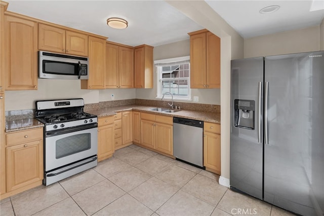 kitchen featuring light tile patterned flooring, light brown cabinetry, sink, and appliances with stainless steel finishes