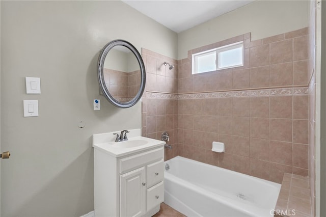 bathroom featuring vanity and tiled shower / bath