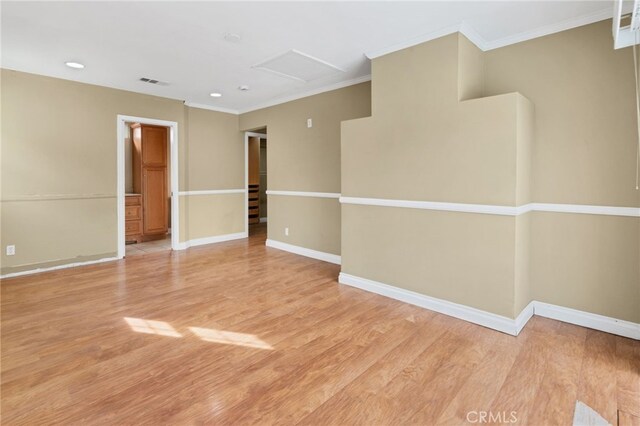 unfurnished room with light hardwood / wood-style flooring and ornamental molding