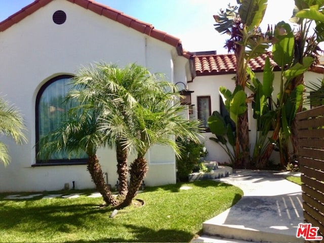 view of home's exterior with a yard