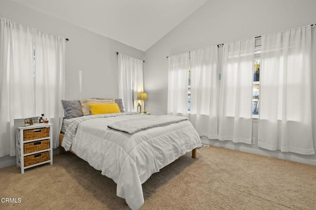 bedroom featuring carpet floors and high vaulted ceiling