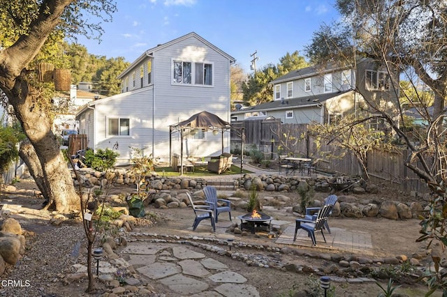 back of house with a patio and a fire pit