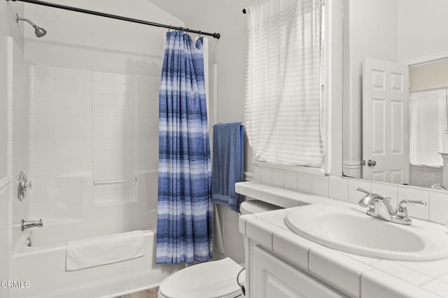 full bathroom with vanity, shower / tub combo, and toilet