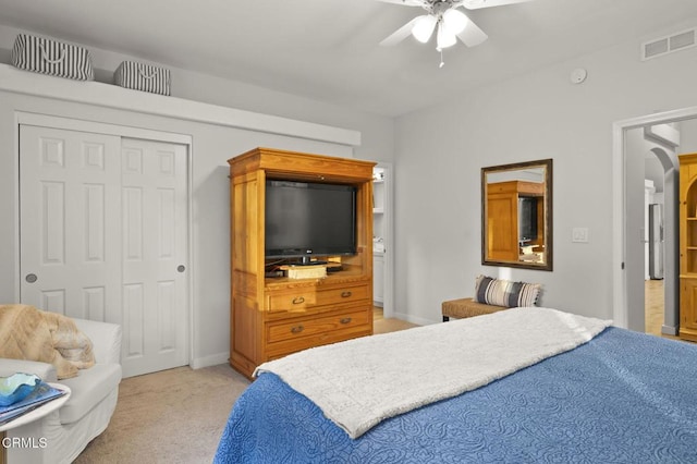 carpeted bedroom featuring ceiling fan and a closet