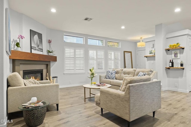 living room with a fireplace and light hardwood / wood-style flooring