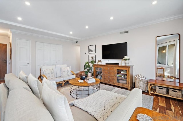 living room featuring wood-type flooring and crown molding