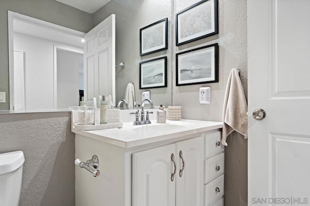 bathroom with toilet and vanity