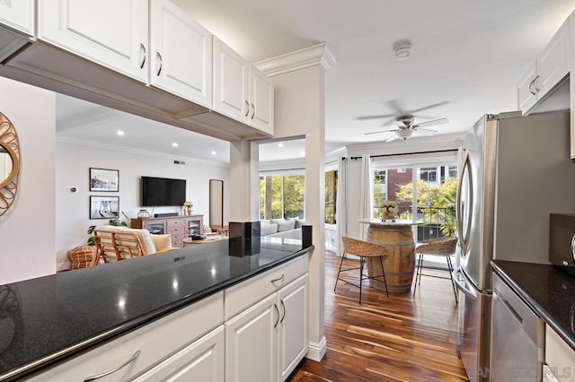 kitchen with ceiling fan, dark hardwood / wood-style flooring, ornamental molding, and white cabinets