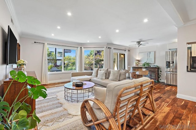 living room featuring dark wood-type flooring, ornamental molding, and ceiling fan