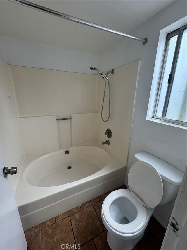 bathroom featuring a healthy amount of sunlight, tile patterned flooring, and toilet