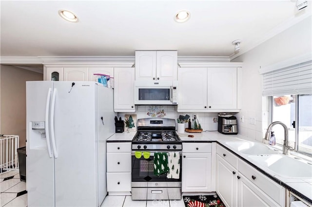 kitchen featuring white cabinets, white appliances, sink, and tasteful backsplash