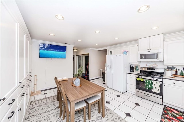 kitchen with white cabinetry, tasteful backsplash, white appliances, light tile patterned floors, and ornamental molding