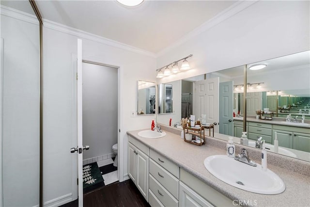 bathroom featuring crown molding, hardwood / wood-style floors, vanity, and toilet