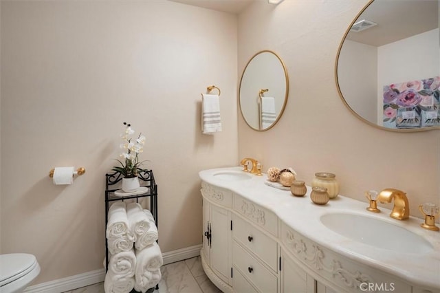 bathroom with vanity and toilet