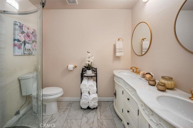 bathroom featuring vanity, toilet, and a shower with door