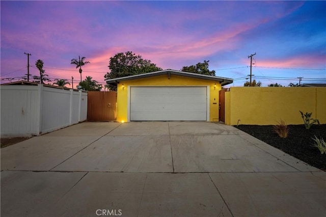 view of garage at dusk