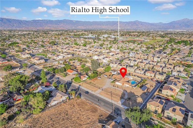 birds eye view of property with a mountain view