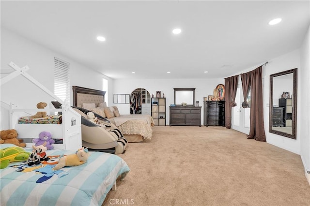 bedroom with light carpet and multiple windows