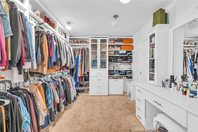 spacious closet featuring light carpet