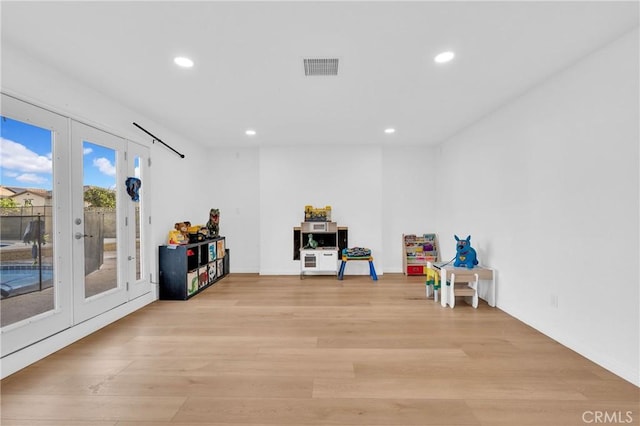 recreation room with french doors and light wood-type flooring