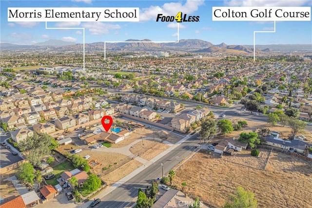 birds eye view of property featuring a mountain view