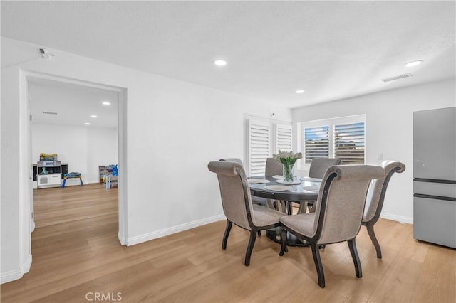 dining area featuring light wood-type flooring