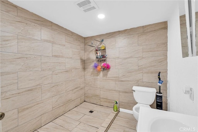 bathroom with toilet and tiled shower