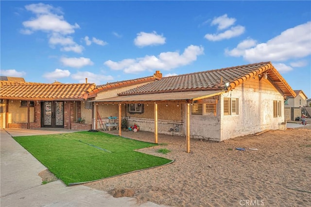 rear view of property featuring a patio area