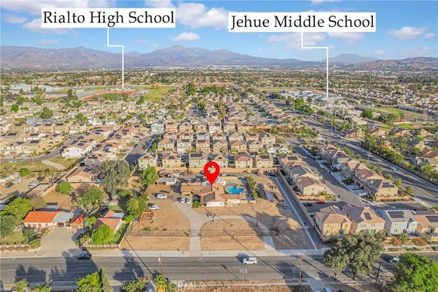 birds eye view of property with a mountain view