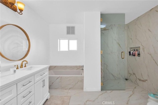 bathroom with vanity and independent shower and bath