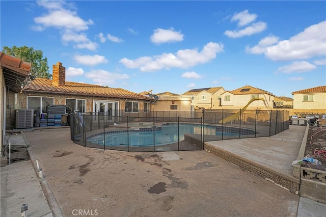 view of pool featuring an in ground hot tub, a patio, and central AC