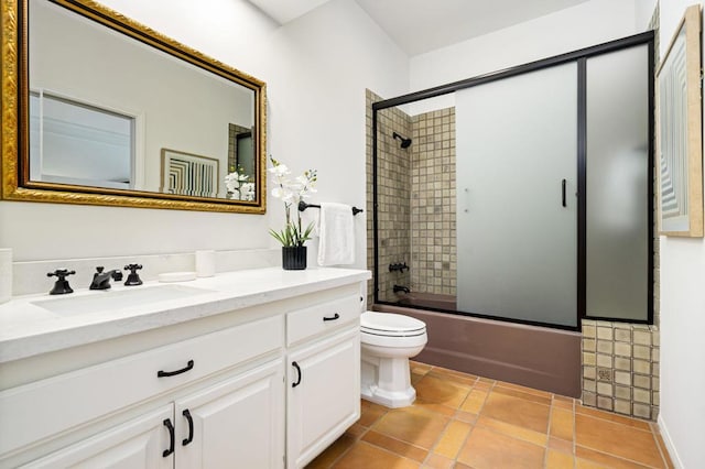 full bathroom with vanity, toilet, and bath / shower combo with glass door