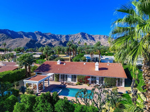 view of swimming pool with a mountain view and a patio