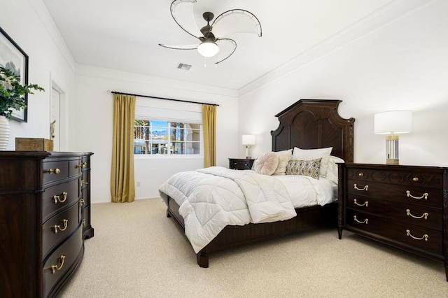 bedroom featuring ceiling fan, crown molding, and light carpet