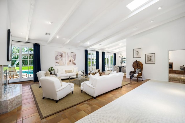 living room with hardwood / wood-style floors, beam ceiling, and a skylight