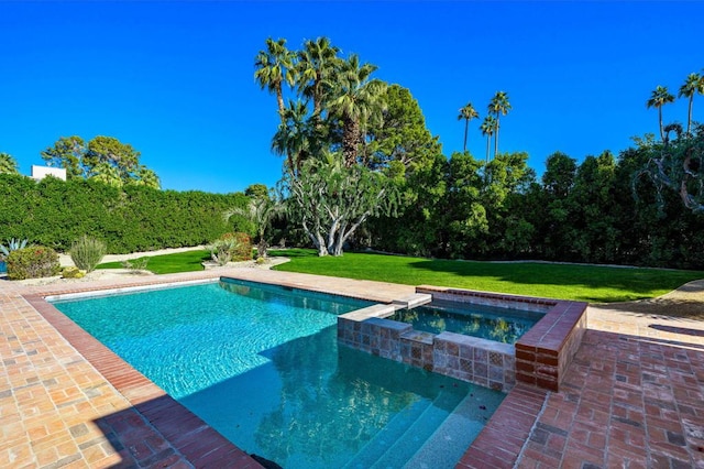 view of pool featuring a lawn and an in ground hot tub