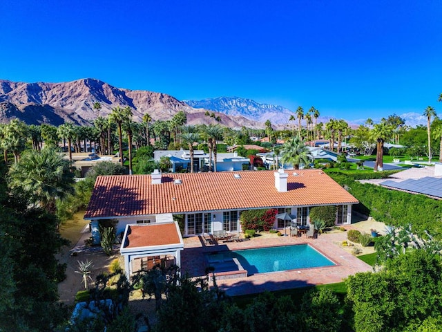 view of pool featuring a mountain view and a patio area