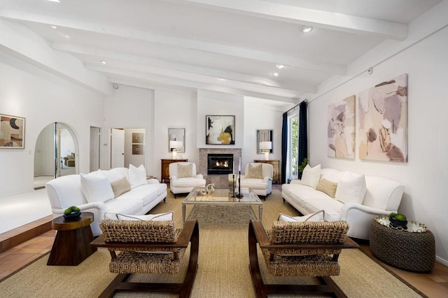 tiled living room featuring vaulted ceiling with beams