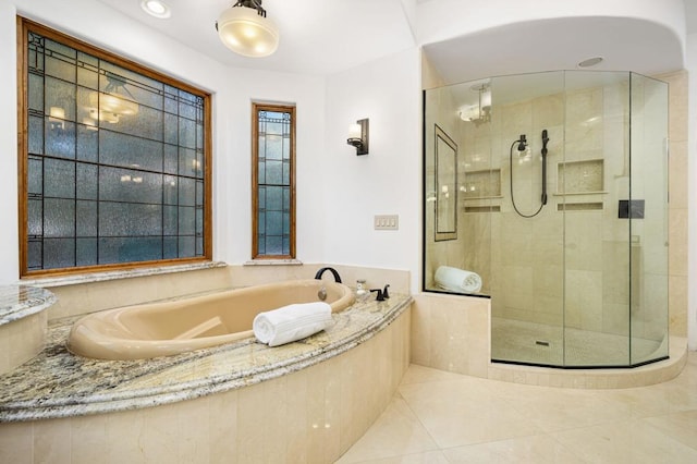 bathroom featuring tile patterned floors and shower with separate bathtub