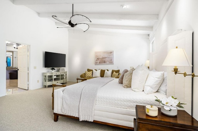 bedroom with beamed ceiling and carpet