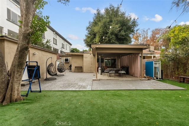 back of house featuring a patio and a lawn