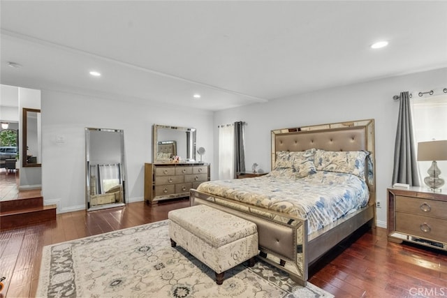 bedroom featuring multiple windows and dark hardwood / wood-style floors