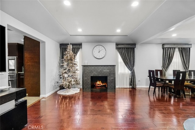 living room featuring a fireplace and dark hardwood / wood-style floors