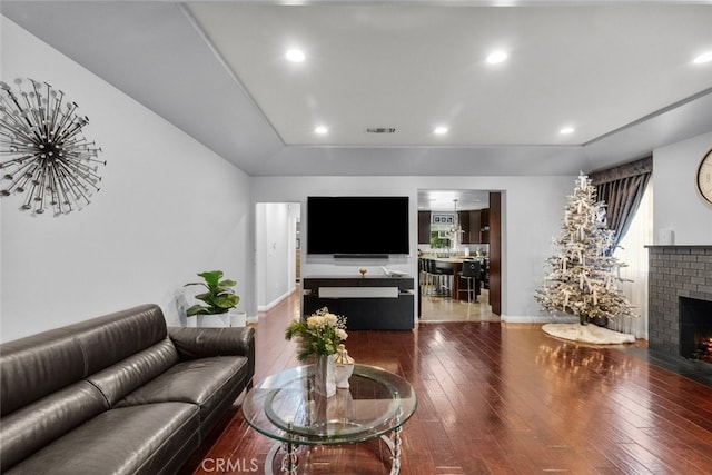 living room featuring a fireplace and wood-type flooring