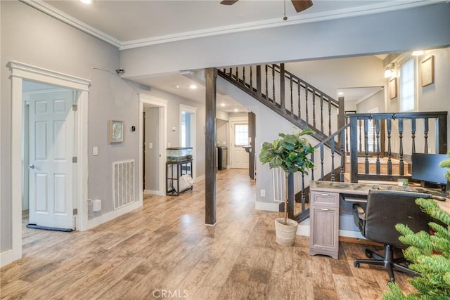 home office featuring crown molding, light hardwood / wood-style floors, and ceiling fan