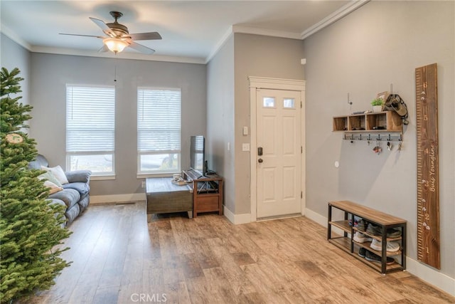 foyer featuring ornamental molding, ceiling fan, and light hardwood / wood-style flooring