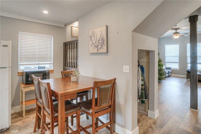 dining area featuring ceiling fan and light hardwood / wood-style flooring