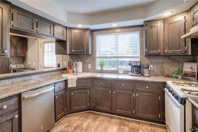 kitchen with dishwasher, white gas range, and dark brown cabinetry