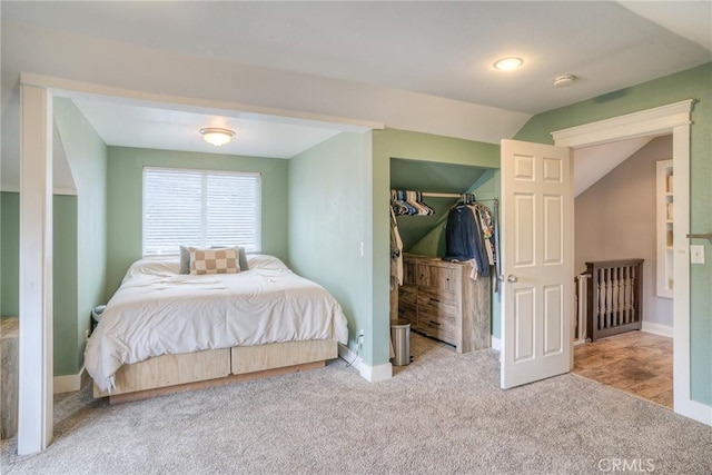 bedroom featuring lofted ceiling and carpet floors