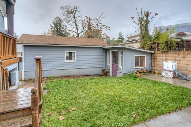 view of front of home featuring a deck and a front yard